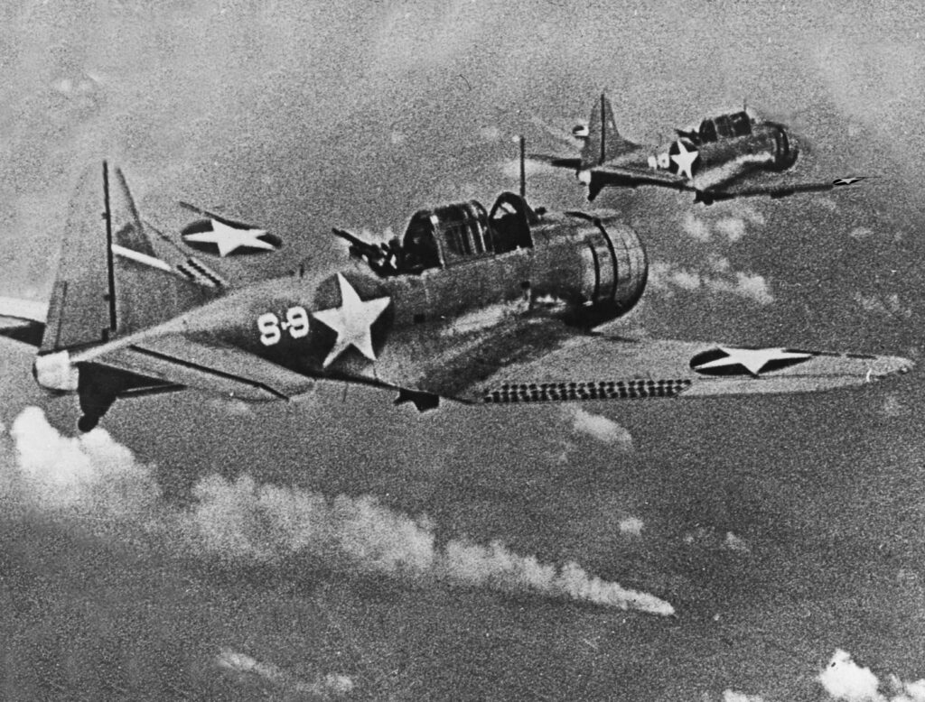 SBD Dauntless bombers over the burning Japanese cruiser Mikuma, 6 June 1942 Douglas SBD-3 Dauntless dive bombers of USS Hornet flying over the burning Japanese cruiser Mikuma during the Battle of Midway, 6 June 1942