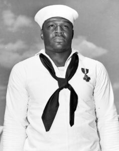Doris Miller in dress whites wearing the Navy Cross, photographed aboard USS Enterprise, May 1942
